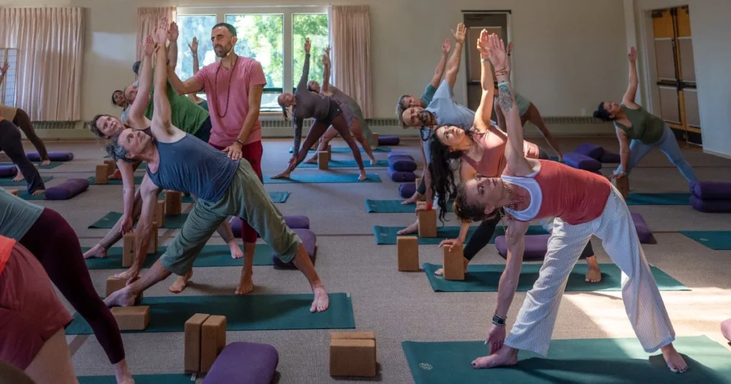 Michael teaching yummy yoga with students in yoga poses