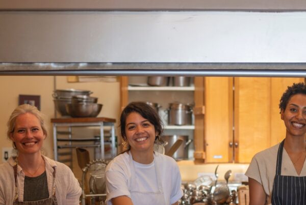 rotational volunteer smiling while working in the kitchen