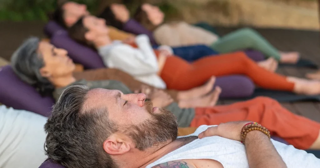 People in restorative yoga poses during yoga class