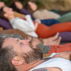 People in restorative yoga poses during yoga class