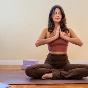 Yoga Teacher Training YTT 200 student meditating while taking online course