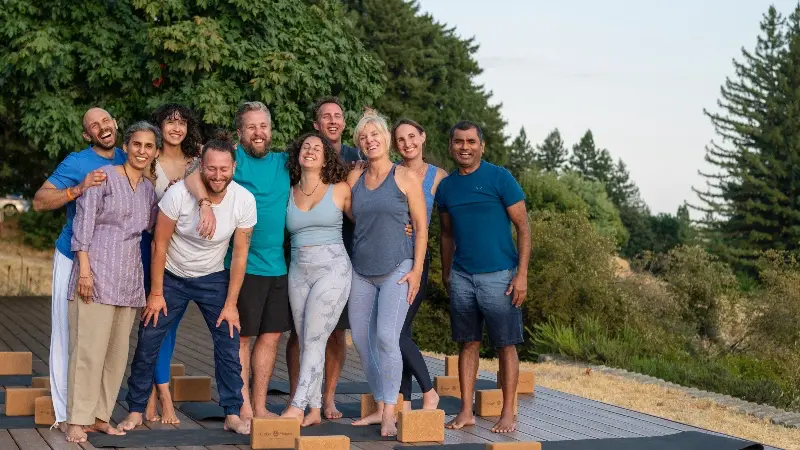Happy group of graduates from Mount Madonna’s 200-hour Yoga Teacher Training outdoors on their final day