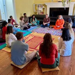 path of bliss meditation and yoga retreat group sitting together in a yellow room