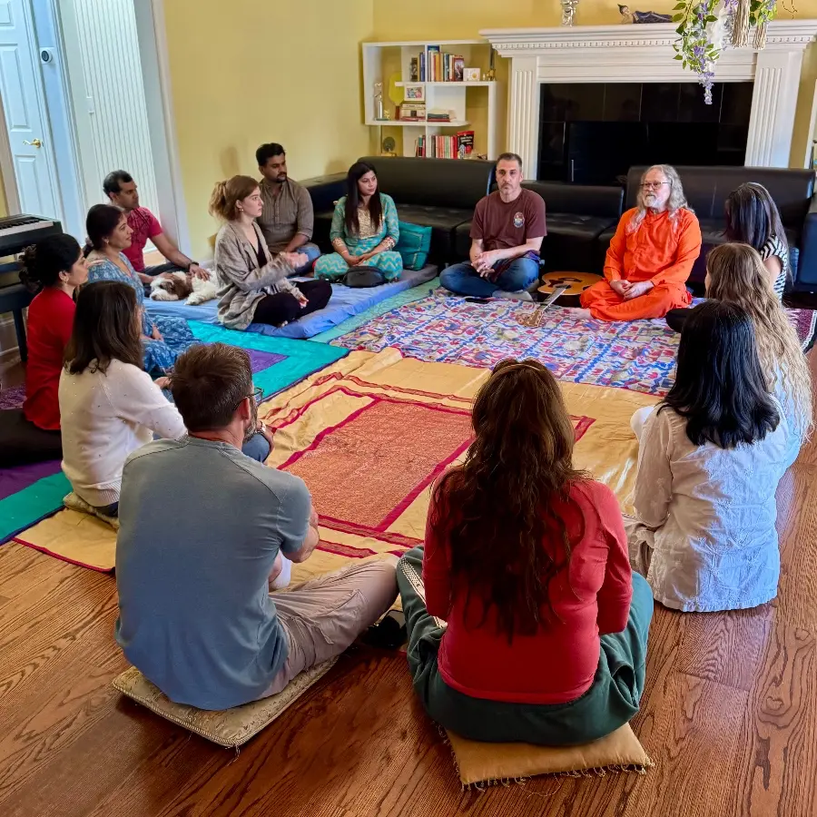 path of bliss meditation and yoga retreat group sitting together in a yellow room