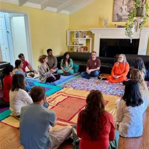 path of bliss meditation and yoga retreat group sitting together in a yellow room