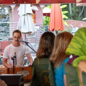 Group of people at the Hanuman Temple gathered for community kirtan (devotional singing)