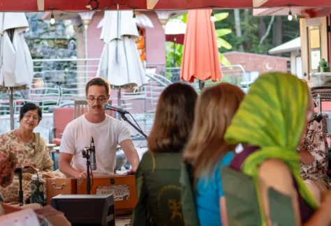 Group of people at the Hanuman Temple gathered for community kirtan (devotional singing)