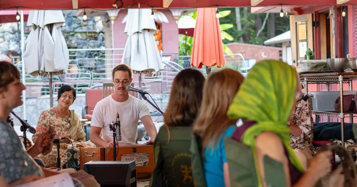 Group of people at the Hanuman Temple gathered for community kirtan (devotional singing)