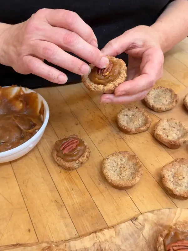 Close-up of Christina, Resident Baker, showing her mini pecan pie recipe