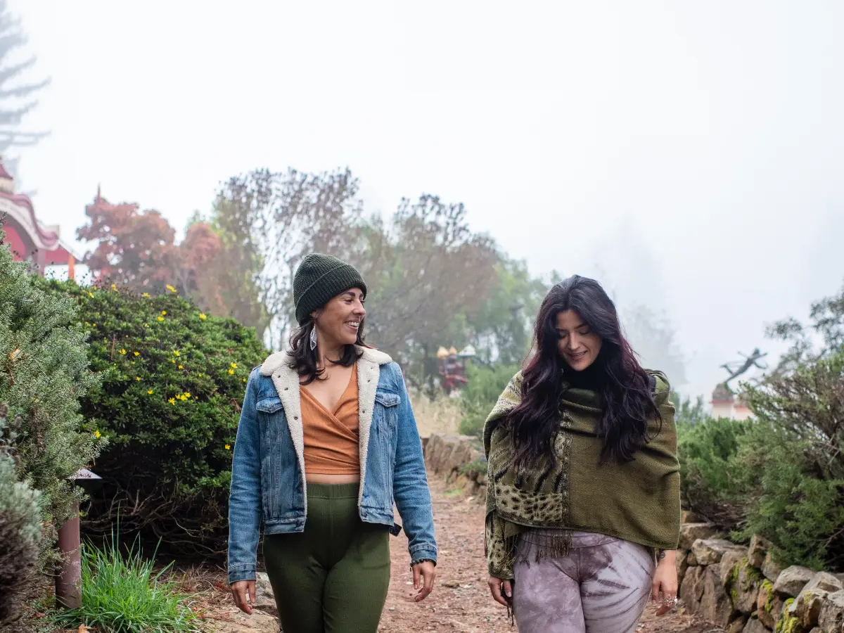 Two New Year's Yoga Retreat participants walk in the fog new Sankat Mochan Hanuman Temple at Mount Madonna
