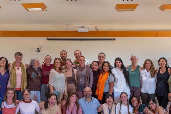 A smiling group of New Year's Yoga Retreat participants