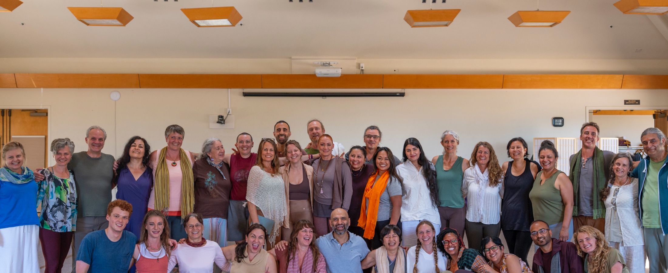 A smiling group of New Year's Yoga Retreat participants
