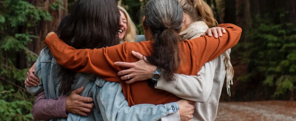 A group of people hugging at Mount Madonna, a Northern California retreat center