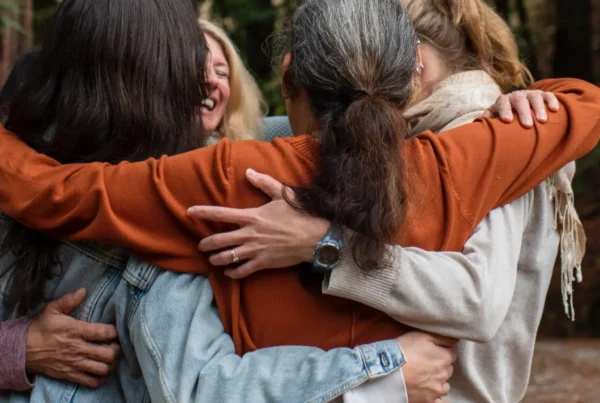 A group of people hugging at Mount Madonna, a Northern California retreat center