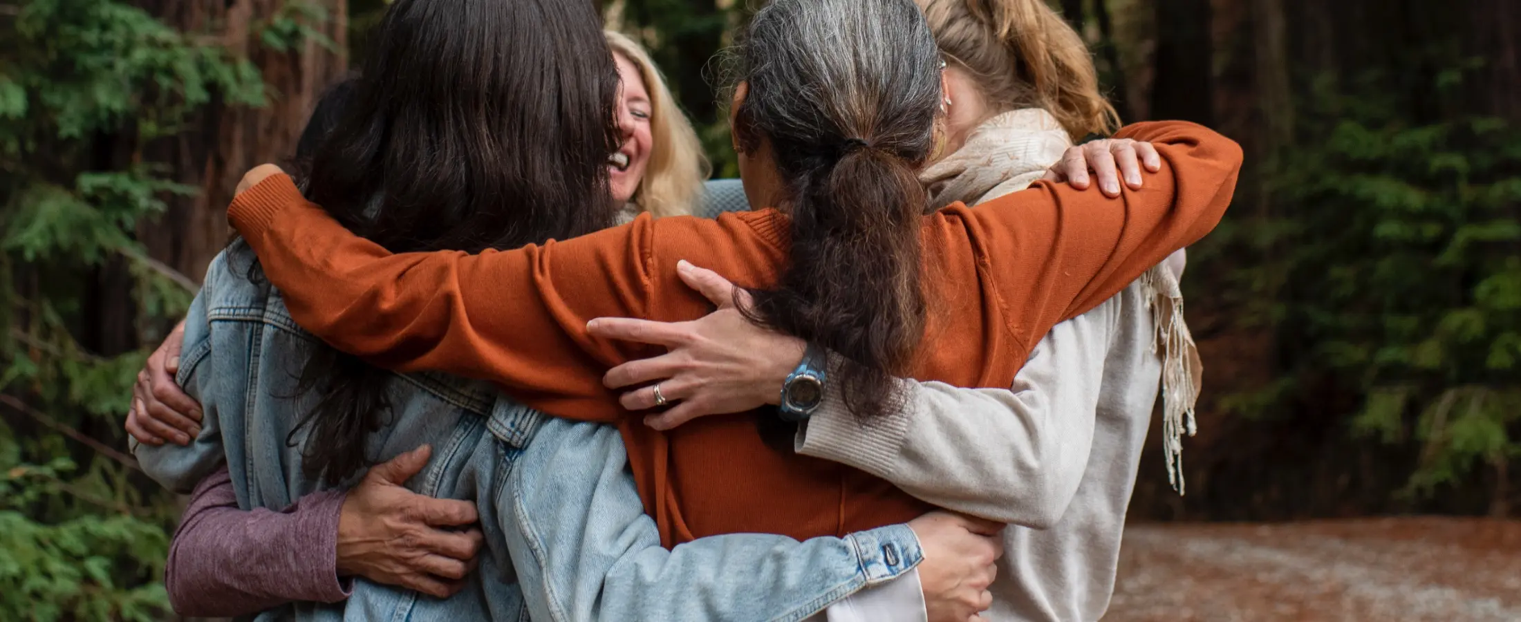 A group of people hugging at Mount Madonna, a Northern California retreat center