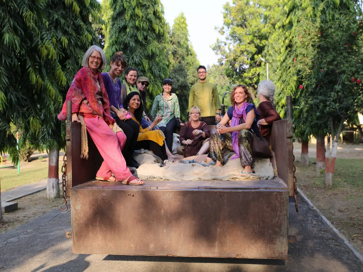 Group of people smiling in the back of a truck at Sri Ram Ashram in Northern India
