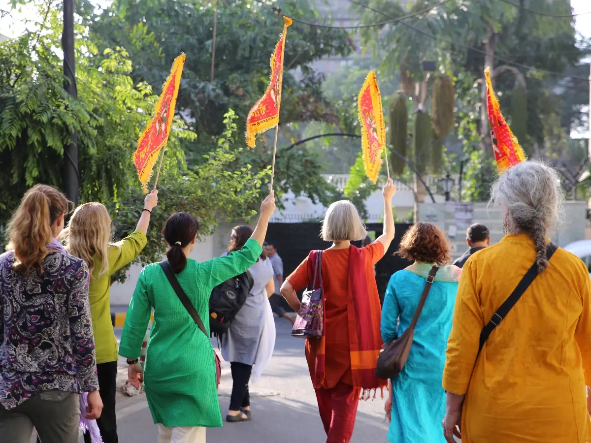 Group of people walking through the streets of India with flags