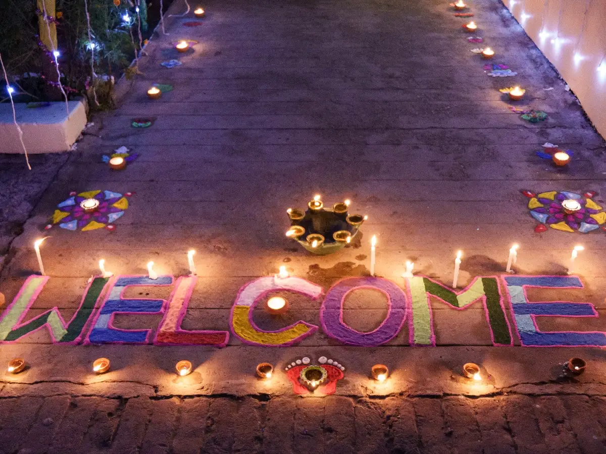 Rangoli on the ground at Sri Ram Ashram in Northern India reads "Welcome" for Diwali