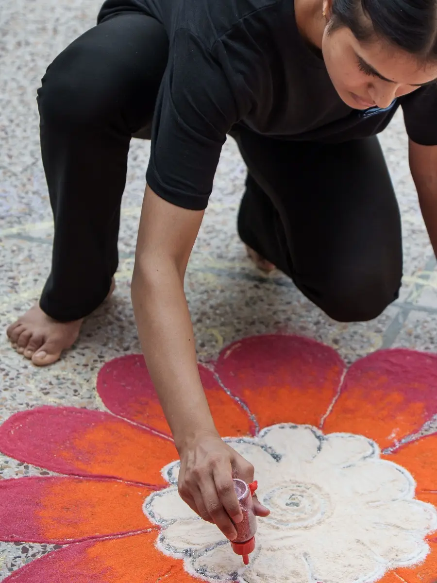 Person creating a rangoli for Diwali at Sri Ram Ashram in Northern India
