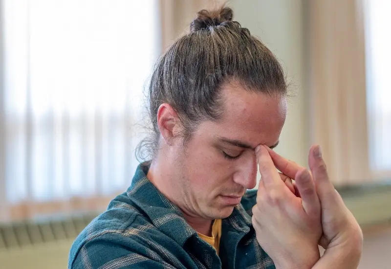 Yoga practitioner drawing the senses inward in a quiet seated practice, illustrating the internal work of advanced yoga studies