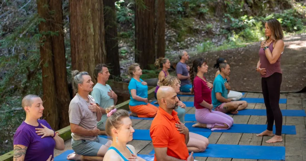 People on bridge in the redwoods for a yoga asana and meditation class at Mount Madonna