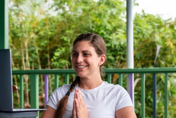 Person on computer for Mount Madonna's Foundational Yoga Studies Online YTT 200 Program