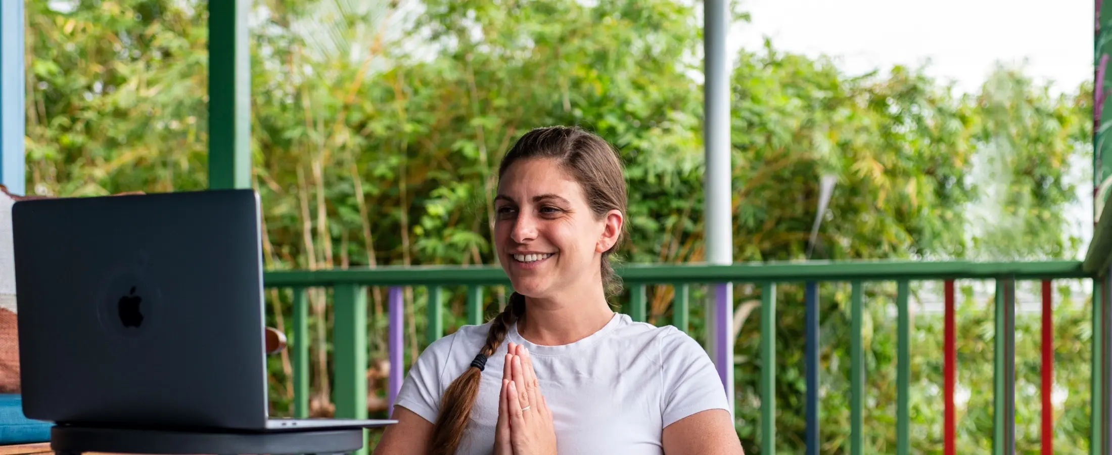 Person on computer for Mount Madonna's Foundational Yoga Studies Online YTT 200 Program