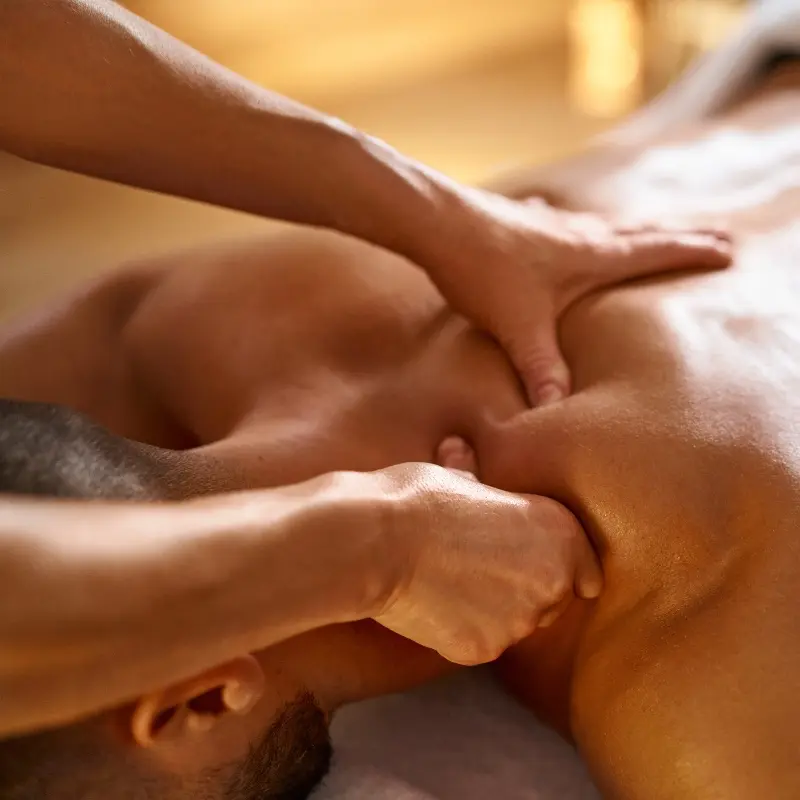 person receiving myofascial release therapy and massage on upper back at Kaya Kalpa Wellness Center