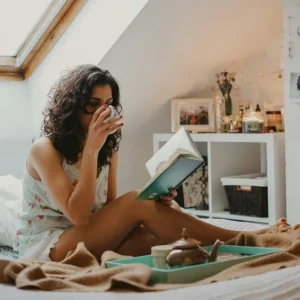Personal sitting in bed for Ayurvedic Lymphatic Self-Care to Clear Your Energy