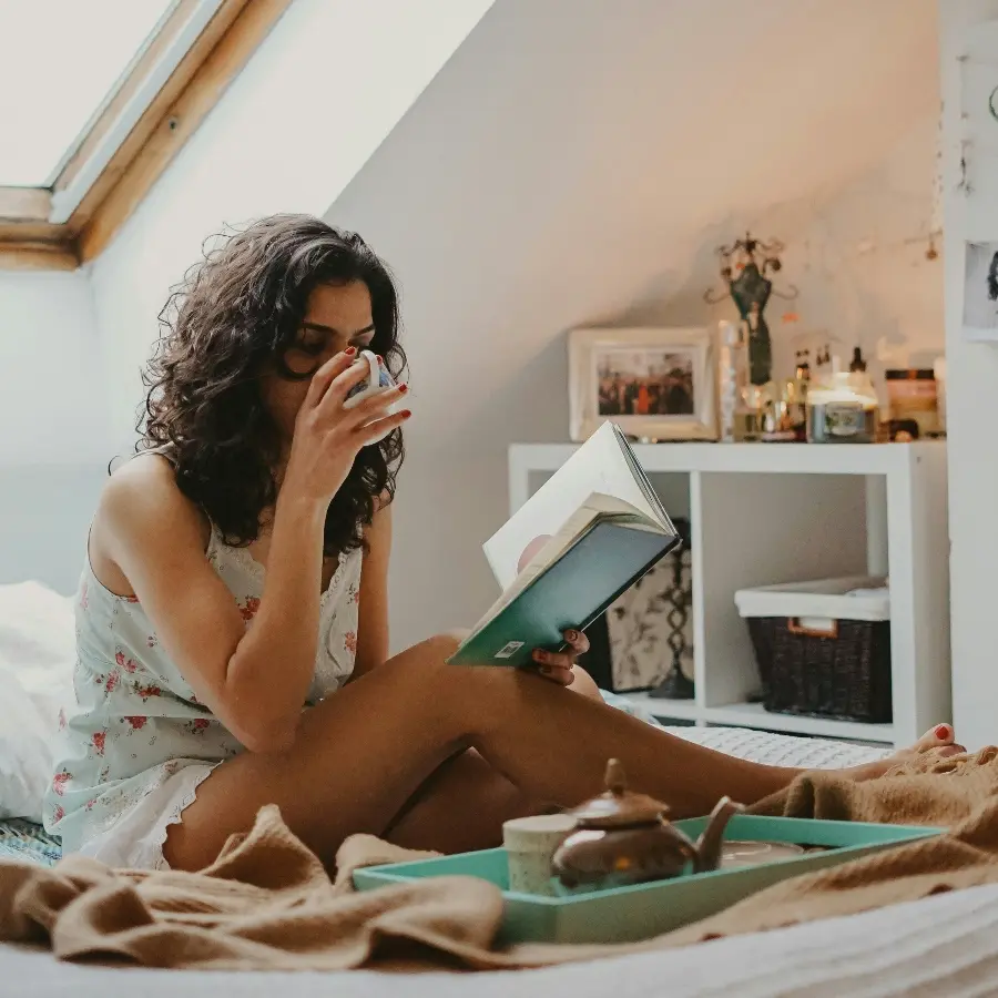 Personal sitting in bed for Ayurvedic Lymphatic Self-Care to Clear Your Energy