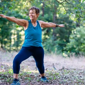 Person outside in warrior 2 pose for online Hatha Yoga class