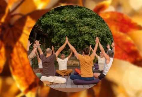 People sitting in circle with arms up for Thanksgiving at Mount Madonna 2026