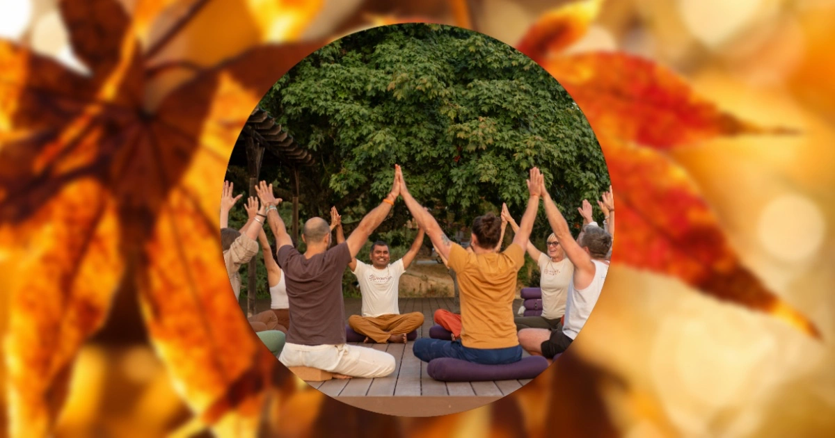 People sitting in circle with arms up for Thanksgiving at Mount Madonna 2026